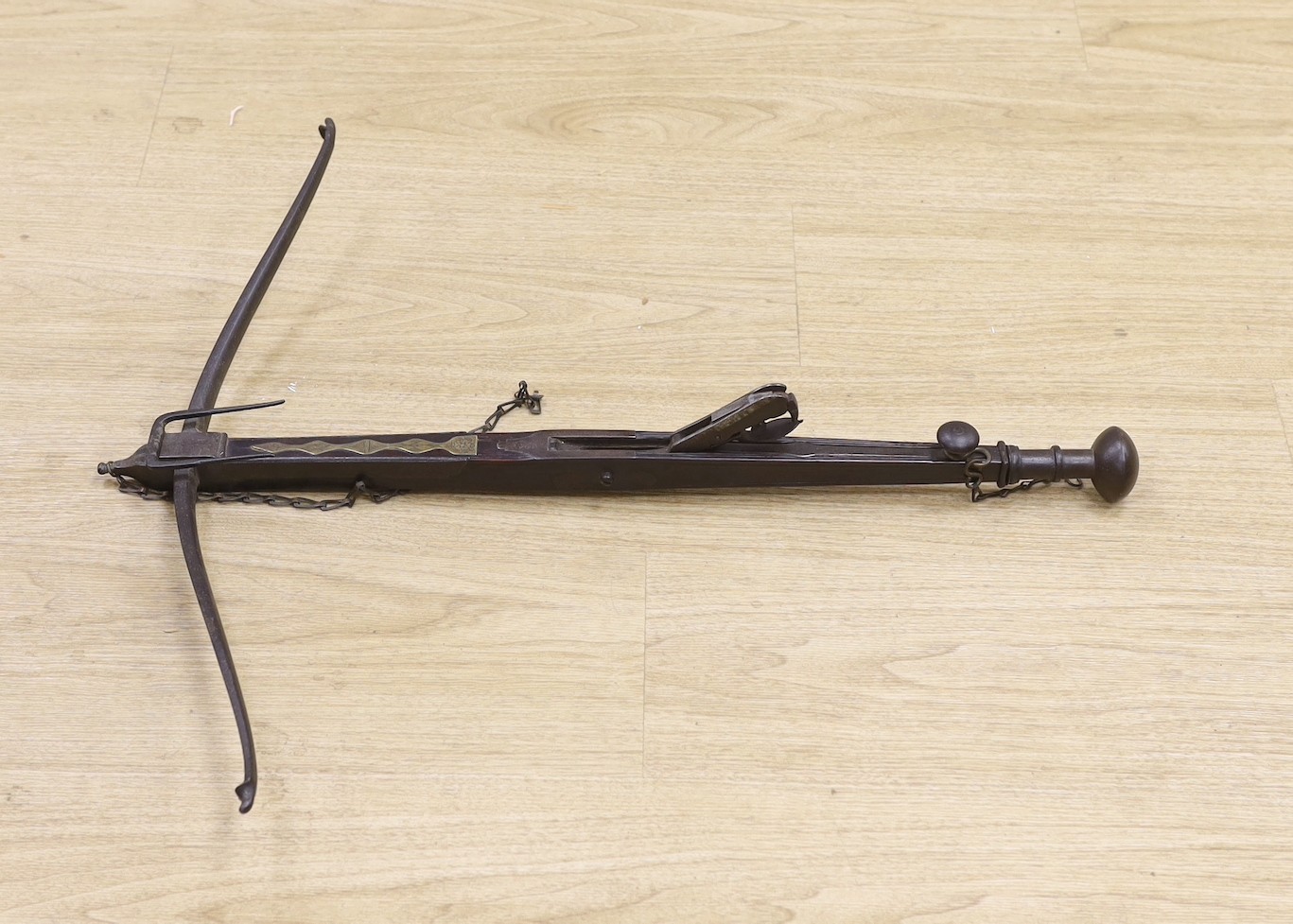 An 18th century English mahogany, brass and iron mounted bullet crossbow, 69cm, pommel end